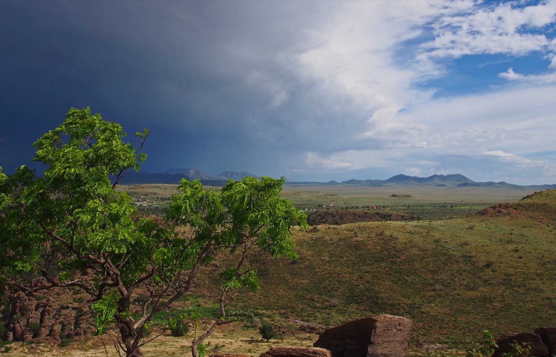 A storm clearing over open country, distant hills on the horizon