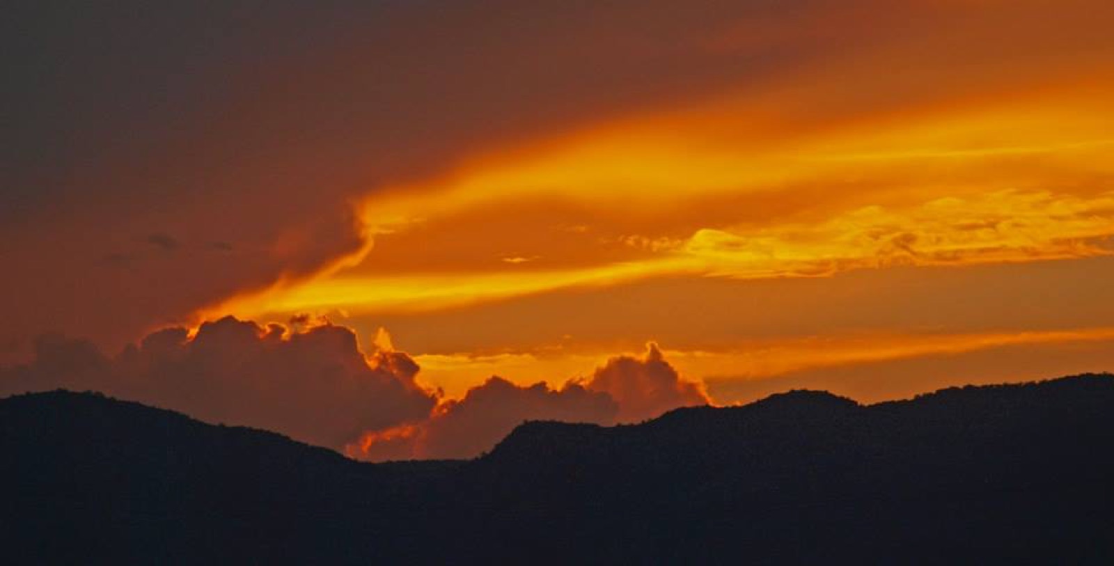 A ridgeline going dark against a low sun